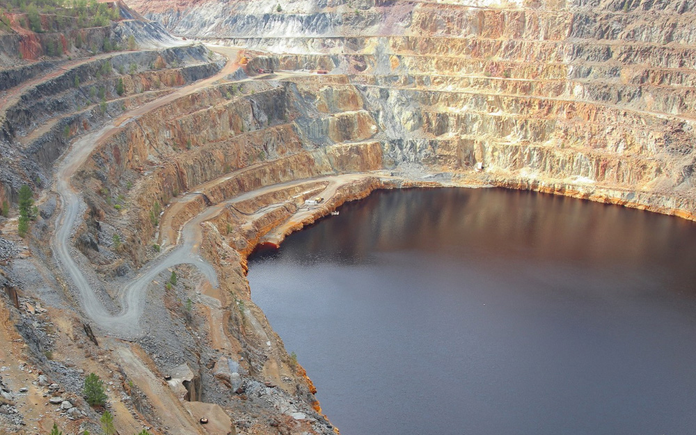 Imagen de una cantera con una balsa al fondo